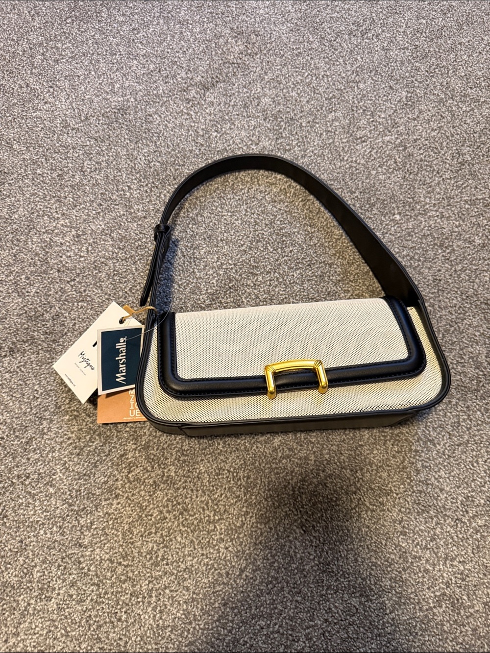 Elegant Cream Canvas and Black Trim Shoulder Bag with Gold Accent